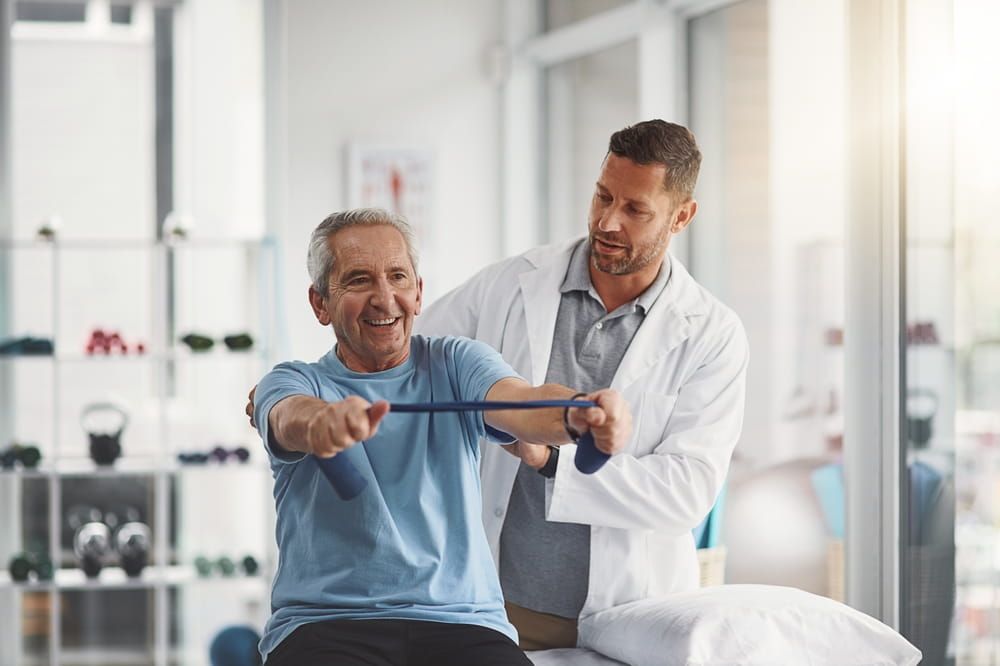 Physiotherapist, stretching band and senior patient for consulting, medical care and wellness.
